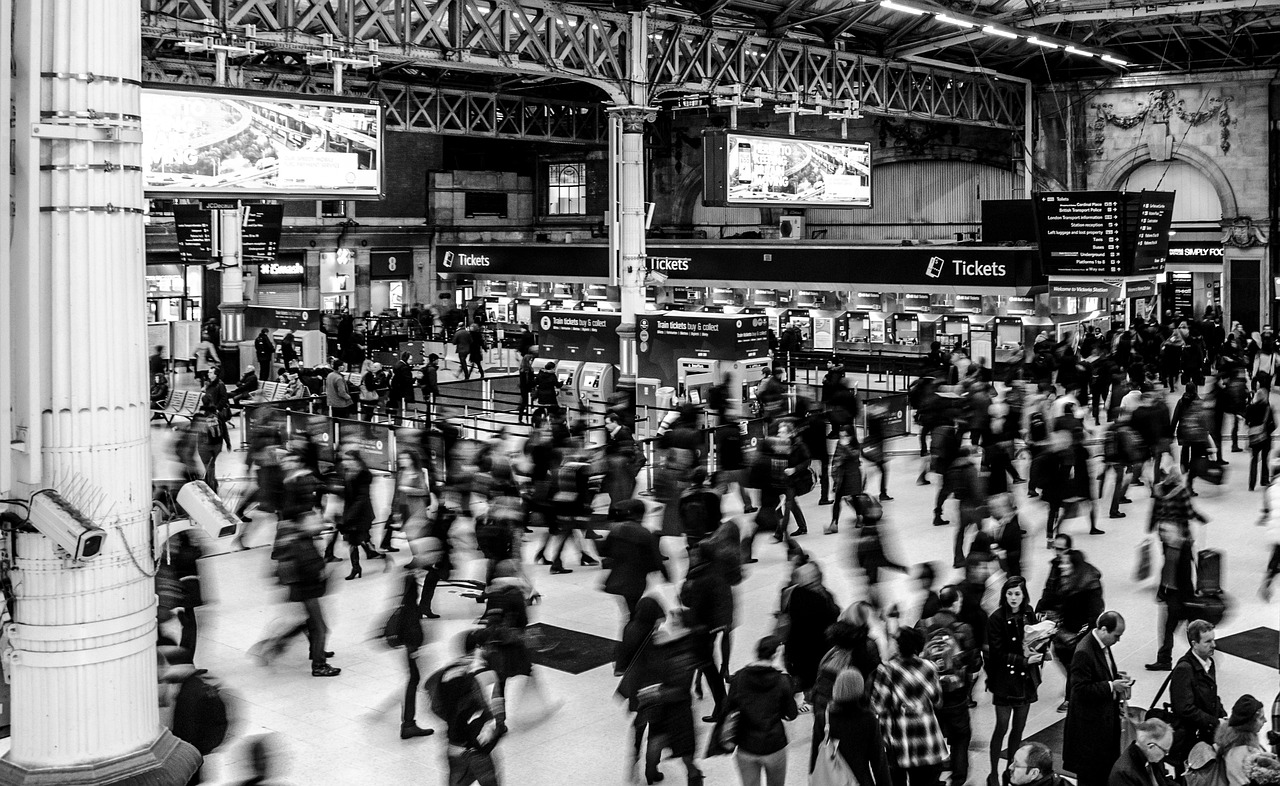 black and white photo of commuters at Victoria Station in London