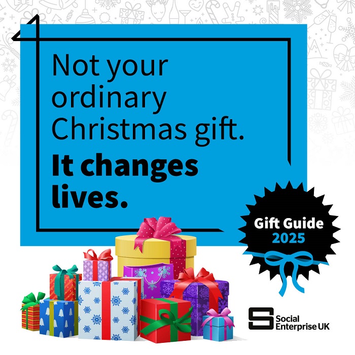 Black text on a blue background sayinf not your ordinary Christmas gift it changes lives, In front there's a picture of a collection of wrapped presents