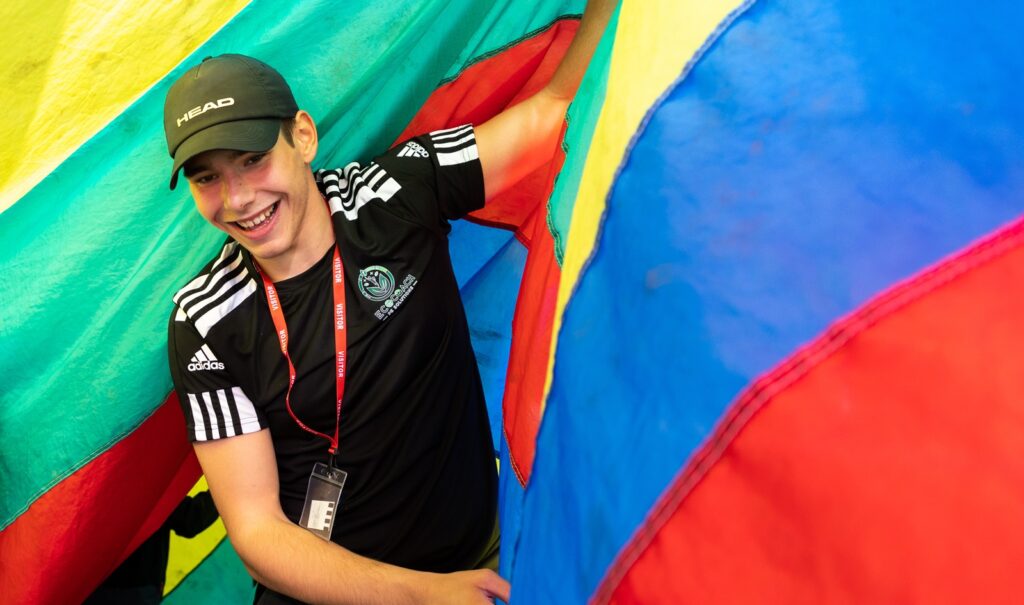 A boy in a basball cap and t-shirt taking part in an activity run by social enterprsie Eco Coach