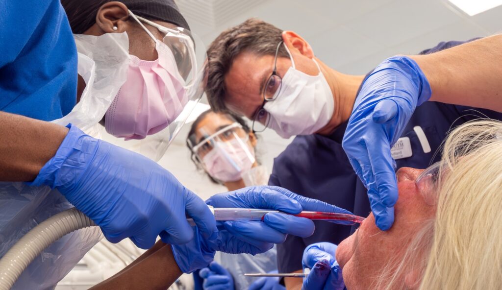 Three staff from Pennunsula Dental carrying out an dental operation