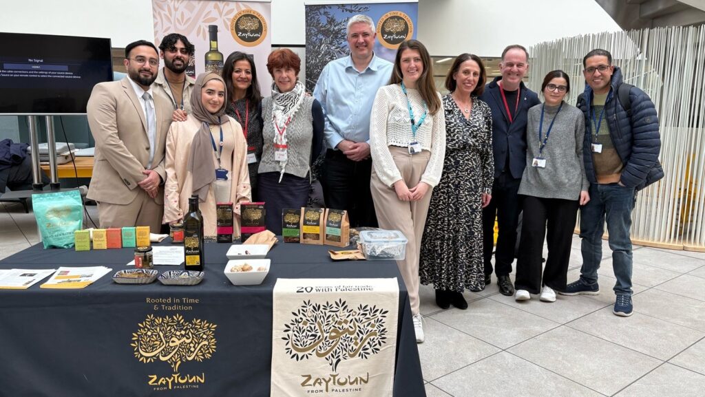 The team from Zaytoun at a stall. On the table is a selection of Palestinian products