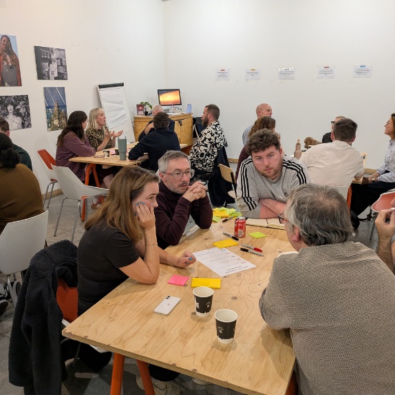a group of people sat arond a table