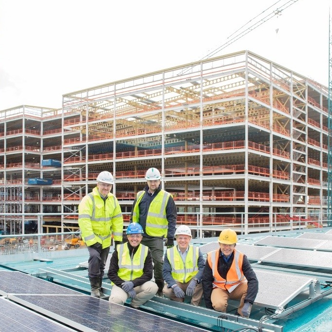 A team of people in hi vis jackets from Planet First Energy installing solar panals